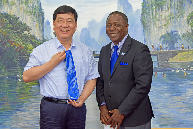 MTSU President Sidney A. McPhee presents a True Blue tie to President Zhao Yueyu of Guangxi University on Tuesday, May 22, in Nanning, China. It was the first meeting between the two presidents, as Zhao assumed leadership of the China university about a year ago. About 40 Guangxi students are pursuing master’s degrees at MTSU. (MTSU photo by Andrew Oppmann)
