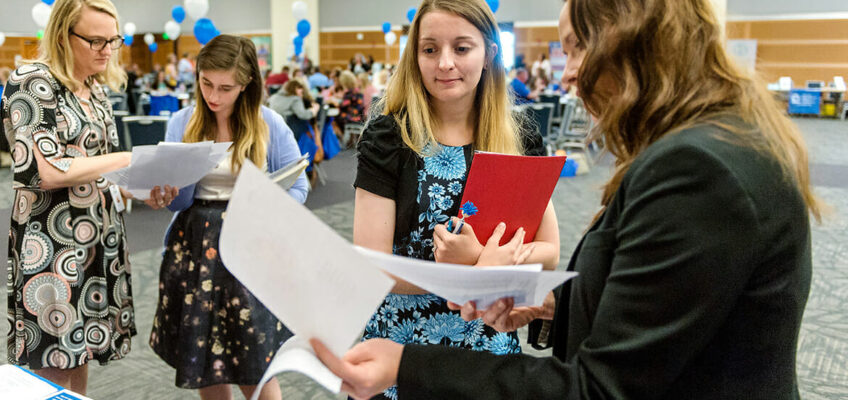 MTSU student teacher Cathy Sherriff, center, talks with Deanna Barnes of Wilson County Schools during the May 2 MTSU Student Teacher Recruitment Fair held in the Student Union Ballroom. (MTSU photo by J. Intintoli)