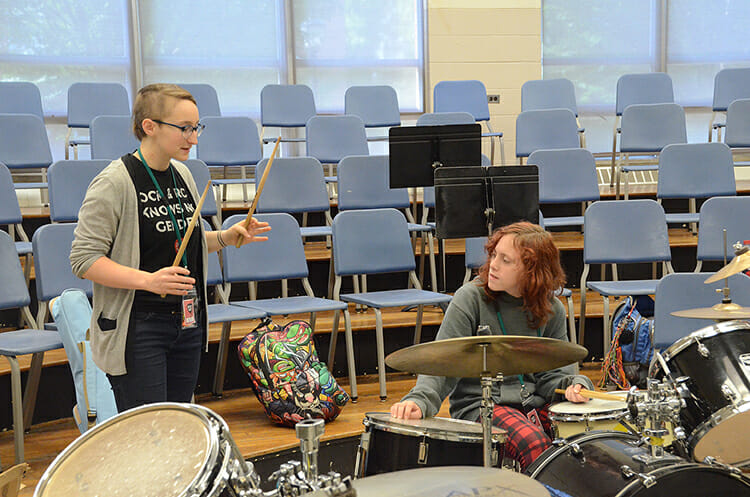 Southern Girls Rock Camp teaching assistant Anna Murphree instructs camper Nina Nooe, 11, on drums inside Wright Music Building during the weeklong camp at MTSU. (MTSU photo by K. Simpson)