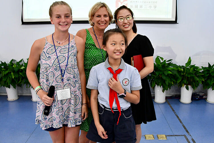 Helen Smith and her mother, Collier, meet their Chinese host family in a July ceremony at a Dongcheng Educational Group magnet school in Hangzhou, China. (MTSU photo by Andrew Oppmann)
