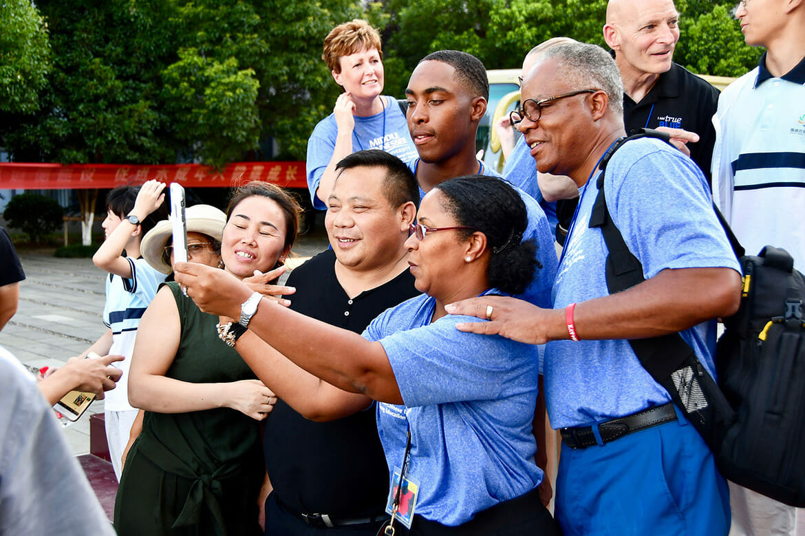 Members of the Reed family — son Justin, with mom Kristal and dad Eric — pose for a selfie with their Chinese host family after a July ceremony at a Dongcheng Educational Group magnet school in Hangzhou, China. (MTSU photo by Andrew Oppmann)