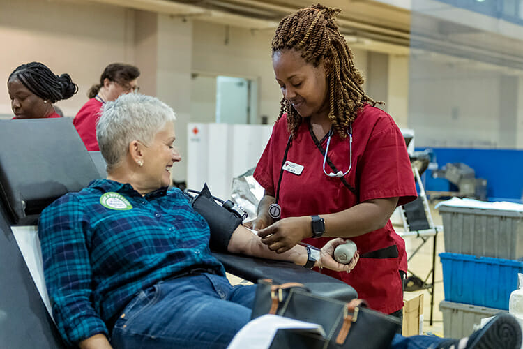 MTSU supporter Martha Tolbert, left, watches while American Red Cross phlebotomist Selina Davis helps her finish donating a pint of blood at the annual "Bleed Blue, Beat WKU" drive in the university's Campus Recreation Center in this October 2018. MTSU’s spring 2019 blood drive is set from noon to 6 p.m. Monday, April 8, in Room 322 inside the Keathley University Center, located at 1524 Military Memorial Drive in the center of campus. (MTSU file photo by J. Intintoli)