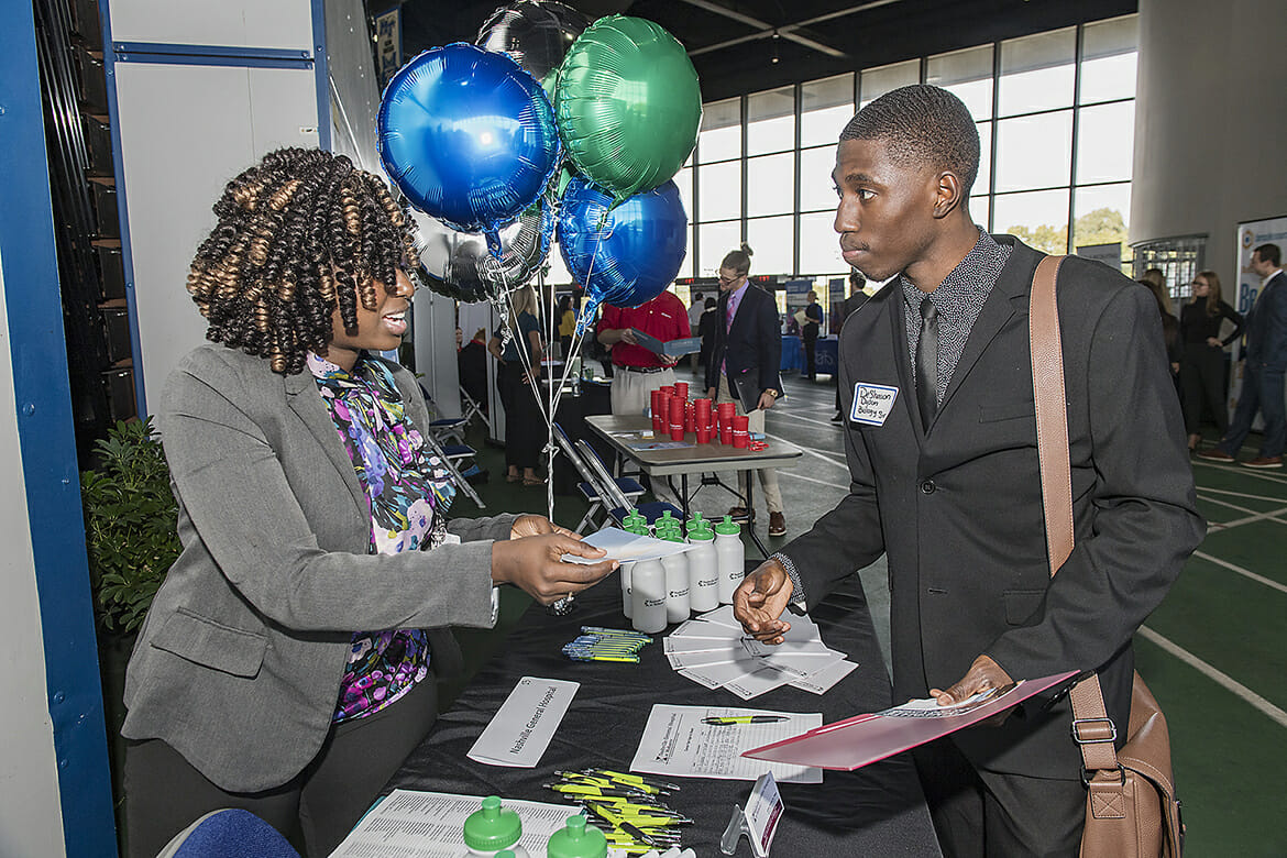 MTSU senior DeShawn Dyson, right, speaks with Ciera Franklin of Nashville General Hospital during the 2018 Fall Career Fair held Wednesday, Oct. 24, at Murphy Center. The event drew several hundred students and alumni and more than 150 employers and graduate/professional schools. (MTSU photo by Andy Heidt)