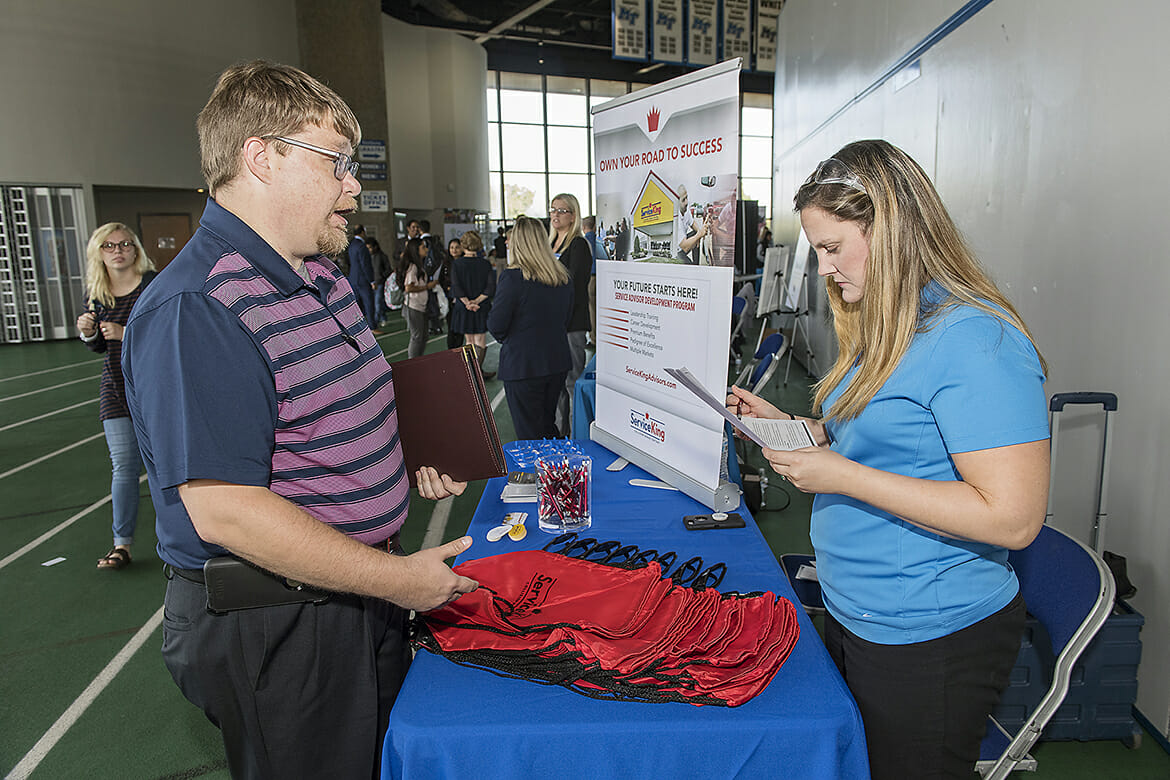 MTSU alumnus Randall Crockett, left, speaks with Natasha Long with Service King during the 2018 Fall Career Fair held Wednesday, Oct. 24, at Murphy Center. The event drew several hundred students and alumni and more than 150 employers and graduate/professional schools. (MTSU photo by Andy Heidt)