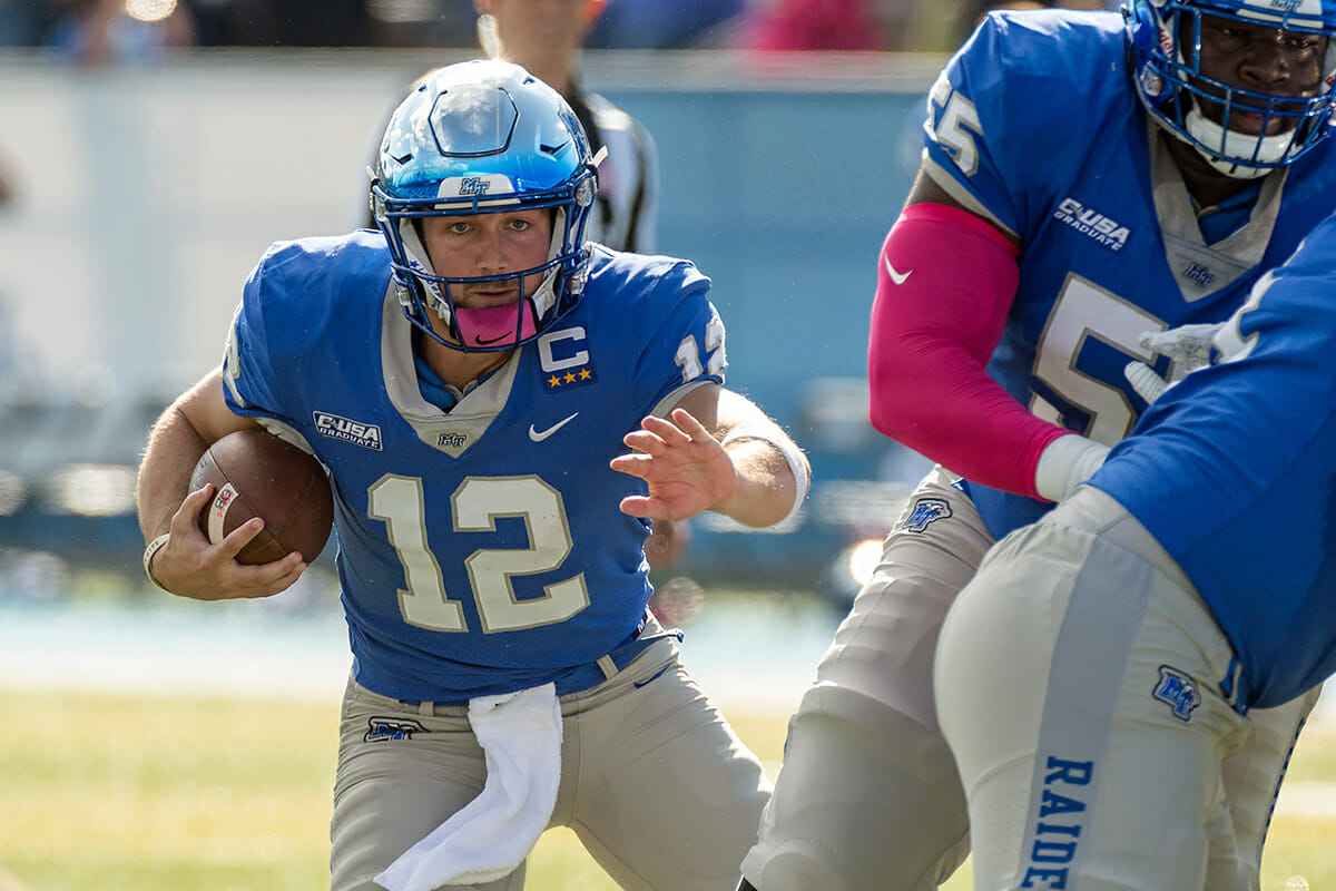 Quarterback Brent Stock-still looks for running room.