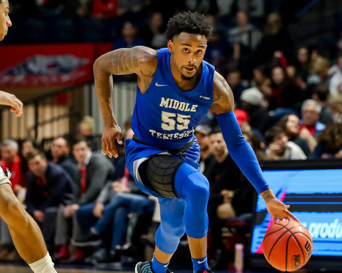 Antonio Green, MTSU Men's Basketball, drives past Belmont defender. Photo by MT Athletics.