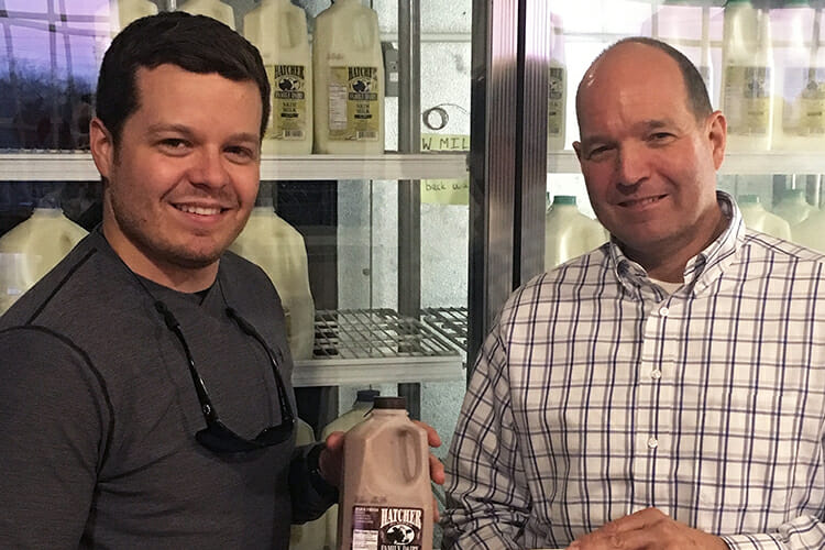 MTSU alumnus and state veterinarian Dr. Charlie Hatcher, right, will be the new commissioner for the Tennessee Department of Agriculture starting in 2019. Gov.-elect Bill Lee made the announcement Dec. 3 in Franklin, Tenn. In this photo, MTSU alumnus Charles Hatcher, left, a member of the Class of 2009, stands in front of a refrigerated case of Hatcher Family Dairy milk with his father, who graduated from MTSU in 1980. (Photo courtesy of Hatcher Family Dairy/EatYall.com)