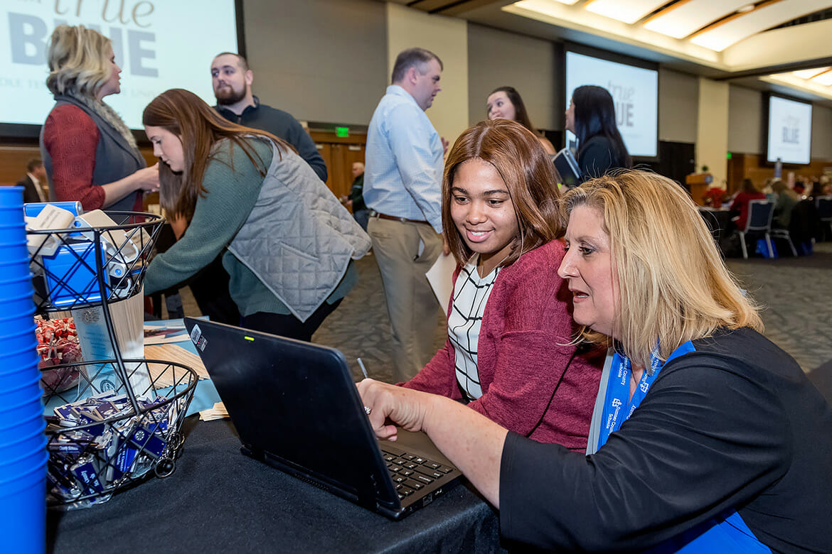 MTSU student teacher Kiara Richardson is assisted by Sumner County Schools recruiter Marla Pike during the MTSU College of Education’s Student Teacher Seminar and Recruitment Fair held Wednesday, Dec. 12, in the Student Union Ballroom. Employers from across the region and as far as China came to meet with graduating student teachers. (MTSU photo by J. Intintoli)