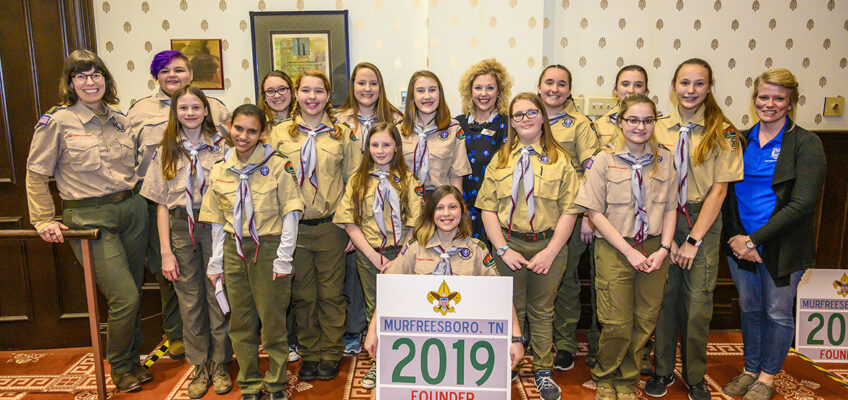 Members of Troop 2019 pose with Middle Tennessee State University employees after Friday’s ceremony to welcome the new all-girl unit into Scouts BSA. (MTSU photo by Eric Sutton)