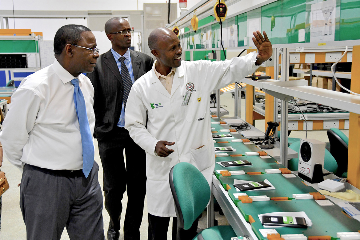 Faculty members from Moi University give MTSU President Sidney A. McPhee, left, a tour of a digital assembly plant that the Kenyan institution operates. (MTSU photo by Andrew Oppmann)