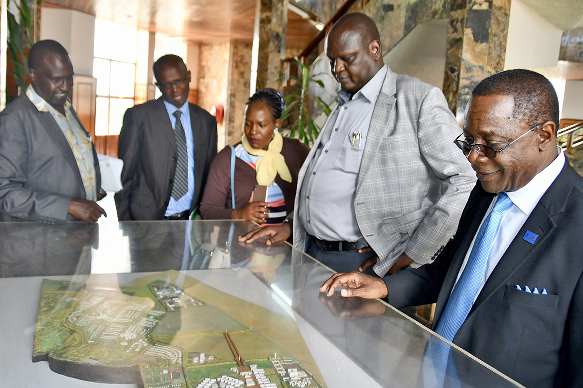 Isaac Kosgey, second from right, chief executive officer of Moi University in Kenya, gives MTSU President Sidney A. McPhee an overview of his campus from a tabletop model. (MTSU photo by Andrew Oppmann)