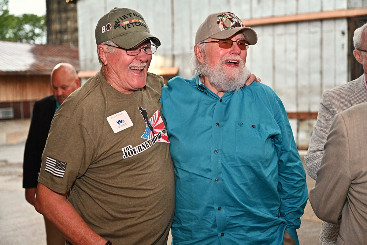 Sporting a T-shirt bearing the name of Charlie Daniels’ foundation, The Journey Home Project, veteran Dennis Buchanan and Daniels share a laugh during the second Veteran Impact Celebration Thursday, June 27, at The Grove at Williamson Place. The Journey Home Project gave $100,000 to the MTSU veterans center for the second consecutive year. (MTSU photo by Andy Heidt/J. Intintoli)