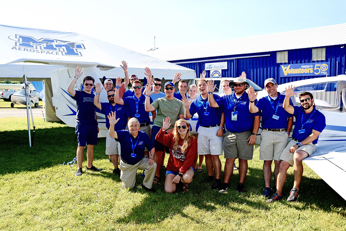 Students, alumni and flight instructors from MTSU’s Department of Aerospace gather around a Diamond DA40 aircraft that the university flew to Oshkosh, Wis., for EAA AirVenture. (MTSU photo by Andrew Oppmann)