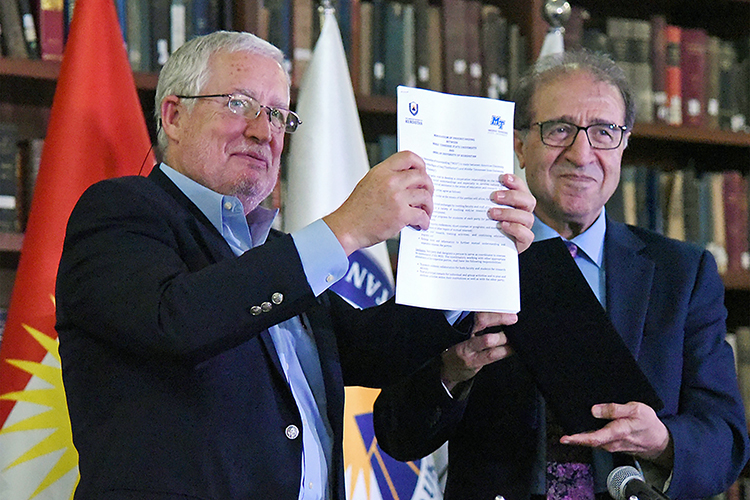 Dr. Peter Cunningham, left, MTSU vice provost for academic programs, joins American University of Kurdistan Provost Nazar Numan in smiling at the assembled crowd's reaction Thursday, July 25, after the universities announced a new international partnership that will allow students to take classes at both institutions to reach their educational goals. Officials formalized the memorandum of understanding between the universities on the AUK campus in Duhok in the Kurdistan Region of Iraq. (Photo courtesy of the American University of Kurdistan)