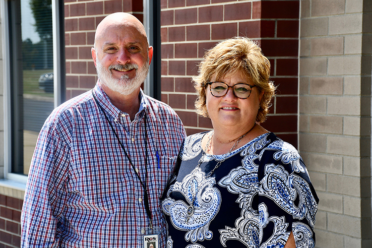 Trey Lee, left, assistant superintendent of engineering and construction for Rutherford County Schools, and his wife, Kim, pose for a photo on the campus of Stewarts Creek Middle School, where Lee’s wife works. Lee completed a 30-year journey to earn his Bachelor of Science in Construction Management in August from MTSU courtesy of MTSU’s flexible degree options. (Photo by MTSU Online)