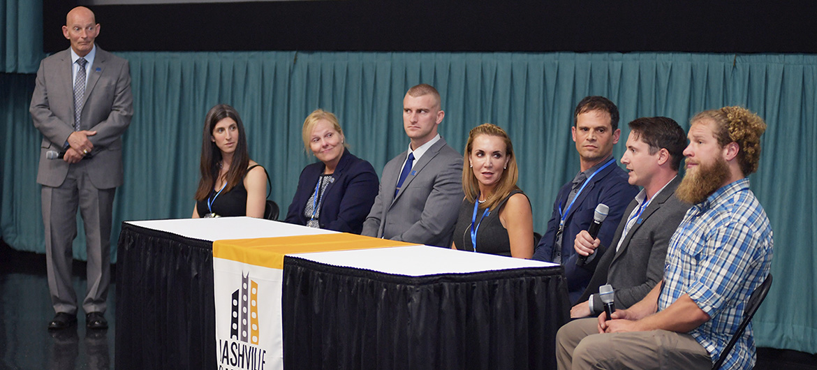 Retired U.S. Army Lt. Gen. Keith Huber, standing far left, MTSU’s senior adviser for veterans and leadership initiatives, moderates a panel Thursday, Oct. 10, at Regal Hollywood 27 following the screening of “Homemade,” a documentary about the post-deployment struggles of a military veteran that was shown at the Nashville Film Festival. Panelists included, seated from left, Danielle Bernstein, “Homemade” producer, editor and co-director; Jennifer Vedral-Baron, VA Tennessee Valley Health Services director; MTSU doctoral candidate and Marine veteran Corbitt Huseth; Hilary Miller, director of MTSU’s Charlie and Hazel Daniels Veterans and Military Family Center; “Homemade” director Jason Maris; U.S. Army veteran and MTSU alumnus Jay Strobino; and U.S. Marine veteran Adam Sorensen, subject of the documentary. (MTSU photo by James Cessna)