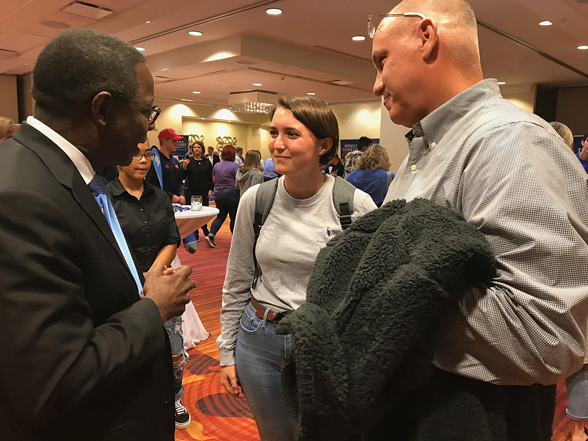 MTSU President Sidney A. McPhee, left, visits with Olivia Porter and her father, Dusty Porter, both of Fort Thomas, Ky., Wednesday, Oct. 16, during the True Blue Tour event to recruit prospective students in Louisville, Ky. (MTSU photo by Randy Weiler)