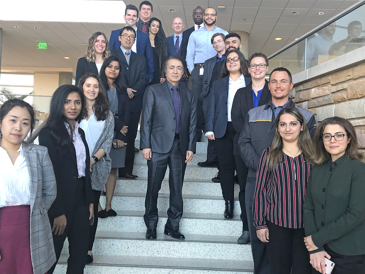 Saeed Foroudastan, center, is flanked by 19 of 22 MTSU Master of Science in Professional Science students who served internships this fall and graduated from the university Dec. 14. The MSPS degrees equip students for successful careers in business, nonprofit, government or the academic world (MTSU photo by Randy Weiler)