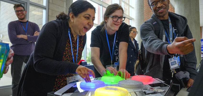 MTSU computer science Chair Medha Sarkar, left, and then-graduate student Steven Sheffey enjoy competing in one of the Infinity team’s games they created during the 36-hour HackMT in the Science Building’s first-floor atrium in January 2020. MTSU team member and current student Myles Chisholm, right, assists. More than a dozen teams will compete in this year’s event, which will be held Jan. 28-30 at MTSU. (MTSU file photo by Cat Curtis Murphy)