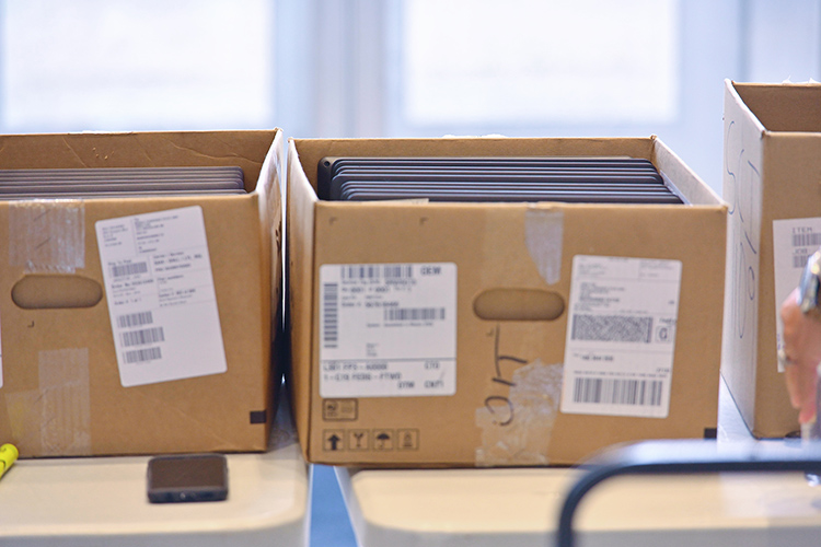 Boxes of laptop computers await checkout in the Cope Administration Building lobby. MTSU’s Information Technology Division has been lending a limited supply of laptops and T-Mobile internet hotspots to students who need it since the university moved to remote courses for the rest of the spring semester. (MTSU photo by Cat Curtis Murphy)