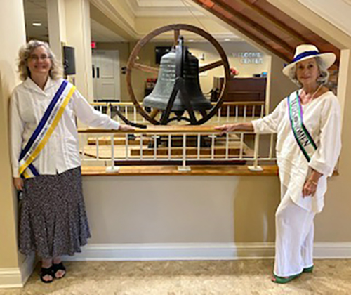 Dr. Antoinette van Zelm, left, associate director of MTSU's Center for Historic Preservation, and Andrea Loughry, vice chair of the Rutherford Arts Commission, pose at the First United Methodist Church in Murfreesboro with the bell that was rung Aug. 28, 1920, to celebrate passage of the 19th Amendment. van Zelm and Loughry rang the bell Aug. 11, 2020, to celebrate the centennial of the event. (Photo submitted)