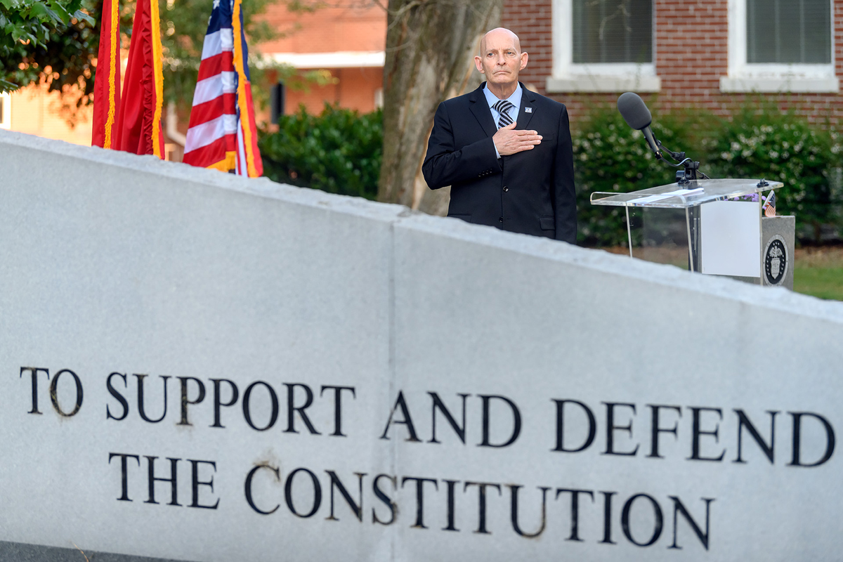 With hand over heart, retired U.S. Army Lt. Gen. Keith M. Huber listens to country/rock singer Rachel Lipsky sing the national anthem that was pre-recorded for the event and part of the 9/11 Remembrance ceremony broadcast on Friday, Sept. 11, from the Veterans Memorial outside the Tom H. Jackson Building. (MTSU photo by J. Intintoli)