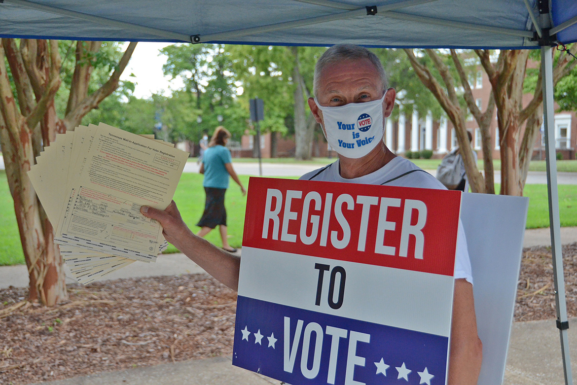 Retired Army Maj. Steve Daugherty holds up several completed voter registration forms filled out by students this week at the American Democracy Project’s voter registration tent on the south side of MTSU’s Peck Hall. The tent will be set up at various locations throughout campus for the next month leading up to the Oct. 5 deadline to register to be eligible to vote in the Nov. 3 presidential election. (MTSU photo illustration by Jimmy Hart)