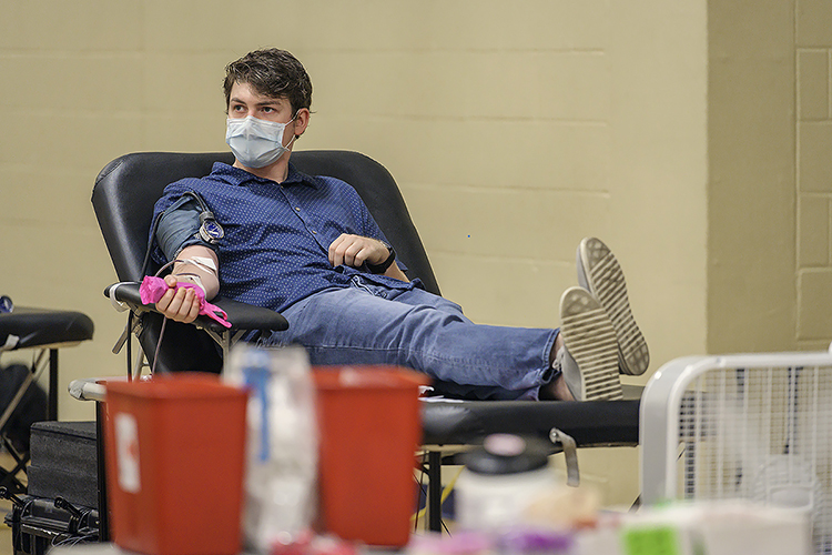 MTSU alumnus Mason Funderburg of Murfreesboro, Tenn., donates blood for the American Red Cross at MTSU’s three-day “Bleed Blue to Beat the COVID-19 Blues” blood drive, held Sept. 28-30 at the neighboring North Boulevard Church of Christ gymnasium. Supporters donated 269 units of blood during the event, potentially helping up to 765 more people across Tennessee and parts of Kentucky, Illinois and Missouri. (MTSU photo by Andy Heidt)
