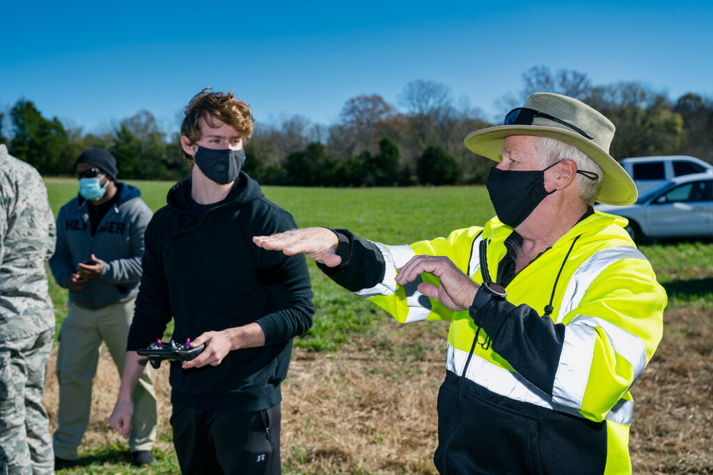 Kevin Corns, Aerospace faculty, with students flying their Unmanned Aerial System aircraft at the MTSU Farm. (Photo: Andy Heidt)