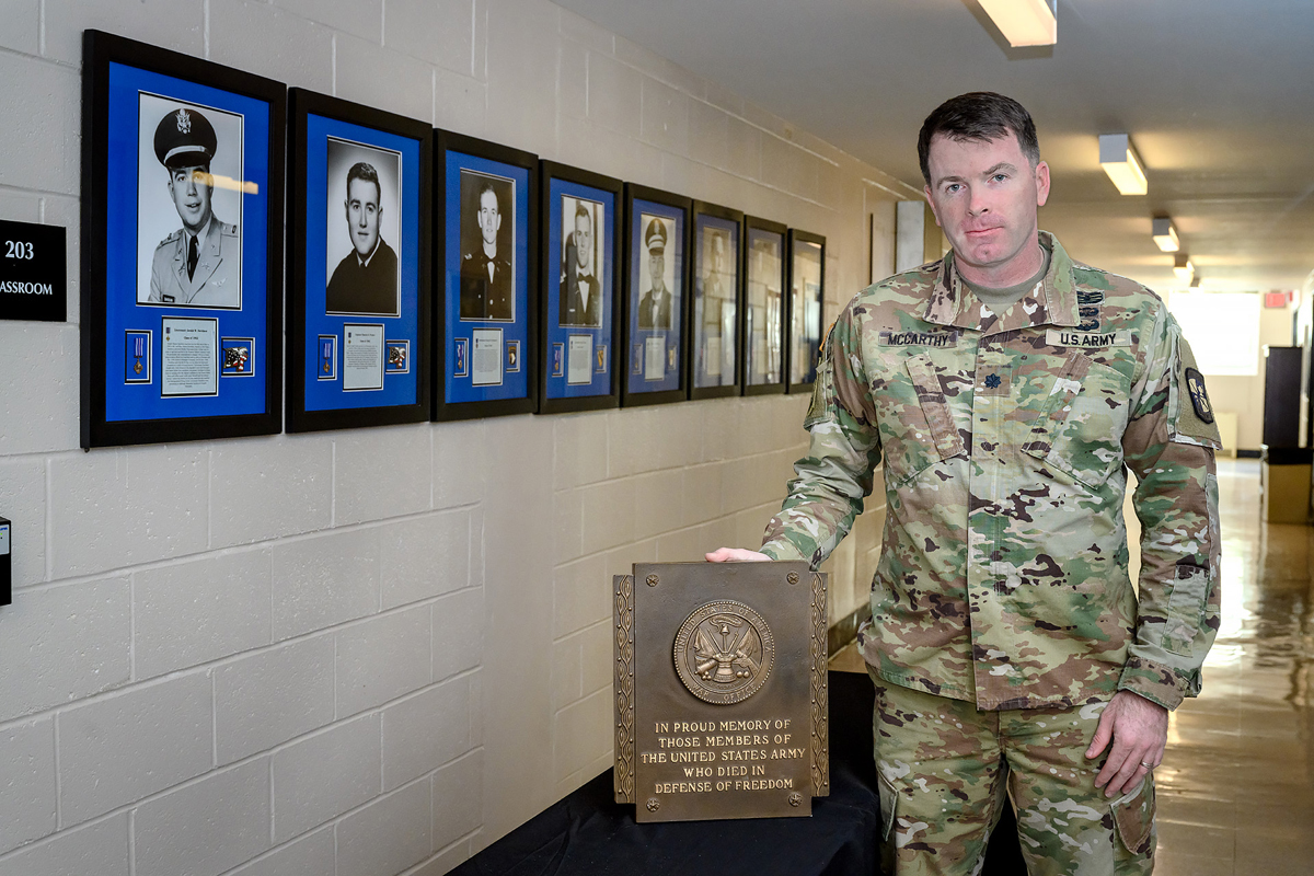 U.S. Army Lt. Col. Carrick McCarthy, who heads the MTSU Military Science program, is shown with a group of eight shadowbox photo displays of former university ROTC cadets who died in combat while serving their country, and an accompanying plaque in Forrest Hall. The shadowboxes will be on display from 12:30 to 2:30 p.m. Saturday, Nov. 7, at the Veterans Memorial outside the Tom H. Jackson Building, 628 Alma Mater Drive, leading to the 39th annual Salute to Veterans and Armed Services game between MTSU and Charlotte in Floyd Stadium. This marks the 70th anniversary of the program. (MTSU photo by J. Intintoli)