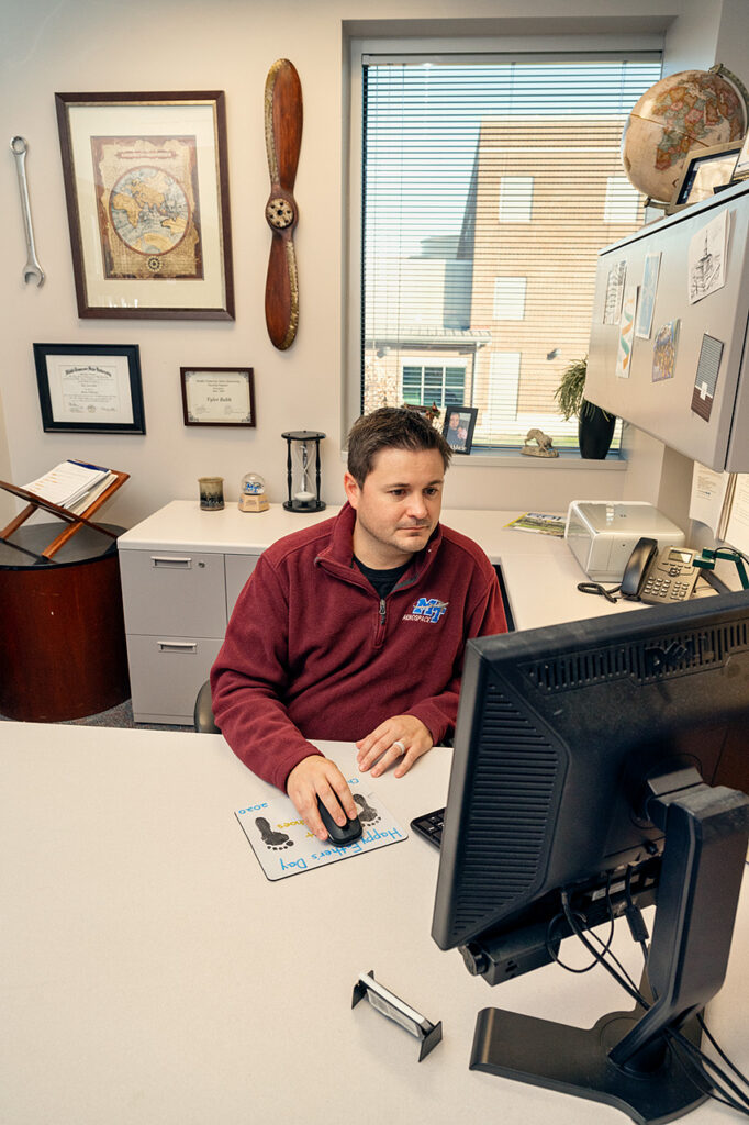 Tyler Babb, Professional Pilot Concentration Coordinator, Aerospace faculty in and around the Business and Aerospace Building. (Photo: Andy Heidt)