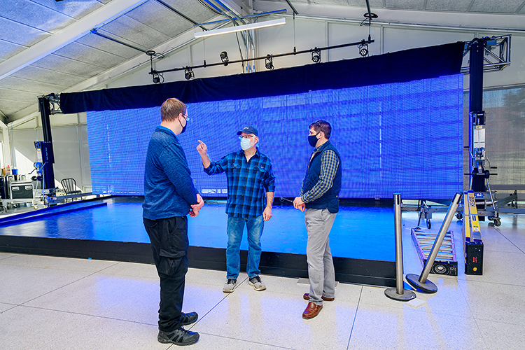 MTSU audio production professor Frank Baird, center, points out an item of interest in the university's new Chris Young Cafe in preparation for a special livestreamed grand opening on Wednesday, Jan. 27, as Mike Forbes, left, assistant director for technical systems in the Department of Media Arts, and Justin Reed, MTSU Student Unions director, listen. The custom LED video wall behind the stage of the refurbished 1963-era cafeteria is part of a transformation into a teaching and rehearsal space and performance venue with help from a $50,000 donation from Chris Young, a former MTSU student turned multiplatinum country entertainer. Baird is also the cafe's new director. (MTSU photo by J. Intintoli)
