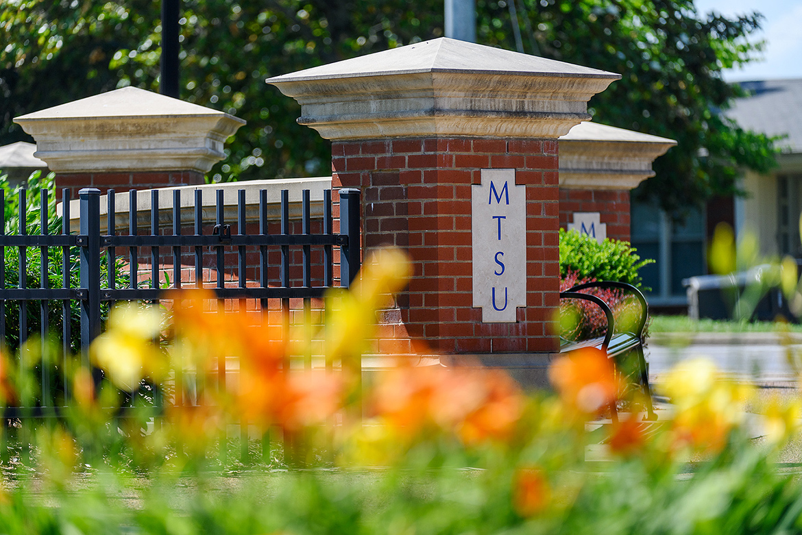 This June 2020 file photo shows the Blue Raider Drive entrance to Middle Tennessee State with blooming flowers. (MTSU file photo by J. Intintoli)
