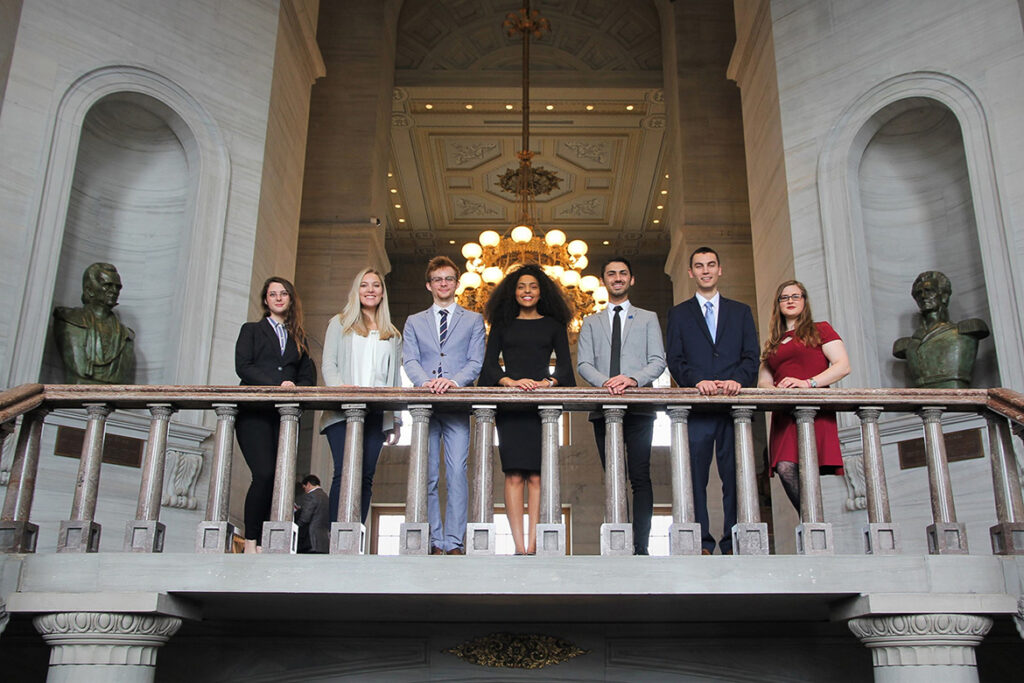 Middle Tennessee State University Undergraduate Research Experience and Creative Activity grant students attended the Posters at the Capitol event in February 2020 to share their research projects with state representatives and stopped for a photo in the Tennessee Capitol in Nashville, Tenn. Standing, from left, are Lily Medley, Lillian Beck, Aric Moilanen, Tia Shutes, Dirhat Mohammad, Jared Frazier and Kayley Stallings. (MTSU photo by Casey Penston)