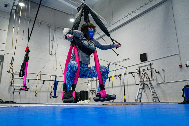 University Studies lecturer Debra Haber demonstrates the PENDL, a new device which purports to help alleviate lower back pain, during a March 26 demonstration in Alumni Memorial Gym. The person can move up and down, sway from side to side and rotate around, depending on the type of exercise one is performing and the therapeutic benefits one is trying to obtain. The Exercise Science Program has conducted evidence-based research into the PENDL. (MTSU photo by Andy Heidt)
