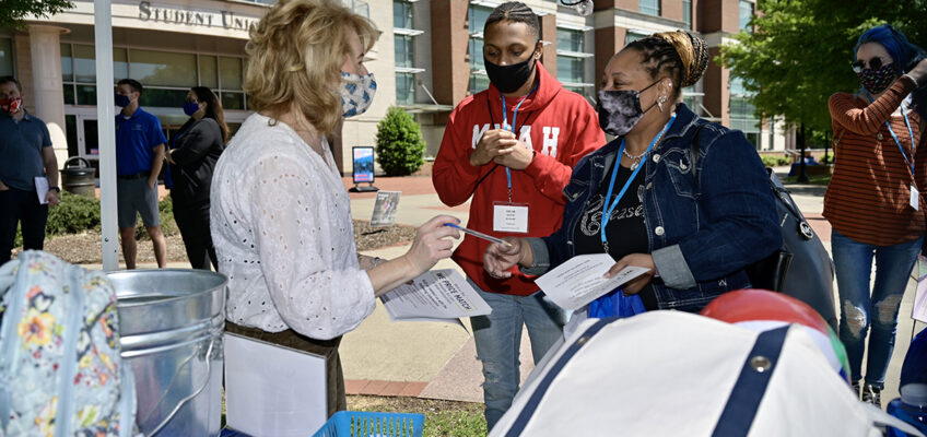 MTSU Phillips Bookstore Manager Natalie Karousatos, left, provides information about the store located inside the Student Union to Micah Davis of Knoxville, Tenn., and his mother, Laronda Turman during their May 13 CUSTOMS orientation visit to campus. They and others attended a Yard Party to learn more about campus departments and student organizations. Orientation will be held for new freshmen and transfers until the first week in August. (MTSU photo by Andy Heidt)