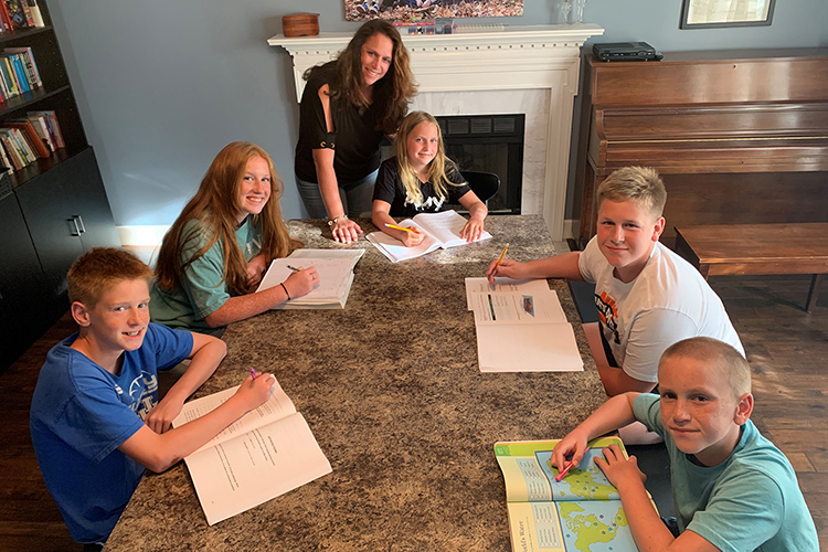 MTSU adult learner Julie Witt of Old Hickory, Tenn., standing, homeschools five of her children as she also pursues completion of her bachelor’s degree in integrated studies after two decades away from the classroom. Pictured with her at their home, from bottom left, are Lincoln, 13; Clara, 16; Noelle, 9; Barrett, 15; and Kenny, 11. (Submitted photo)