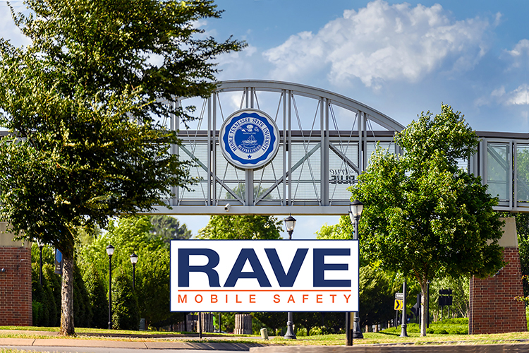 This file image shows the Blue Raider Bridge, connecting MTSU's Student Union and Student Services and Admissions Center, and the crosswalk for pedestrians below on Blue Raider Drive, plus the Rave Mobile Safety logo superimposed onto the photo. (MTSU file photo by J. Intintoli)