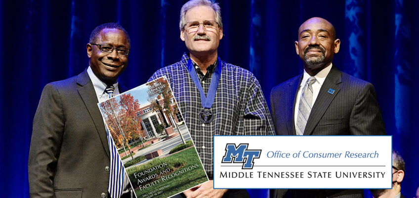 MTSU marketing professor Timothy Graeff, center, proudly wears his new Career Achievement Award medallion Thursday, Aug. 19, after receiving the university's top teaching honor from President Sidney A. McPhee, left, and alumnus Ronald Roberts, vice president of the MTSU Foundation in Tucker Theatre during the 2021 Fall Faculty Meeting. Graeff also is founder of MTSU’s Office of Consumer Research. Ten more MTSU professors also were recognized by the MTSU Foundation with awards for their for their accomplishments in and outside the classroom, and McPhee presented his 2021 State of the University address during the gathering. (MTSU photo by Andy Heidt)