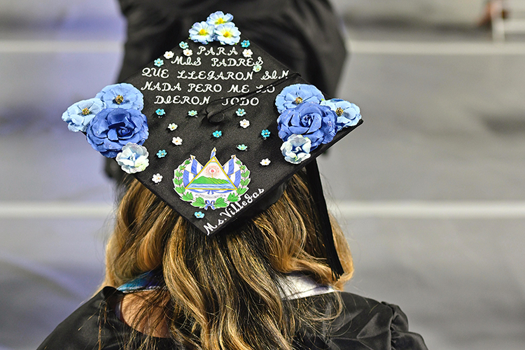 New MTSU College of Education graduate Andrea Villegas proudly wears her customized mortarboard during the university’s spring 2021 three-day weekend of commencement ceremonies in May. Villegas, who now teaches at Stewartsboro Elementary School, wrote "For my parents, who came with nothing but gave me everything" on her graduation cap. MTSU students will return to Murphy Center Saturday, Aug. 7, for the university's summer 2021 commencement ceremony. (MTSU file photo by Cat Curtis Murphy)