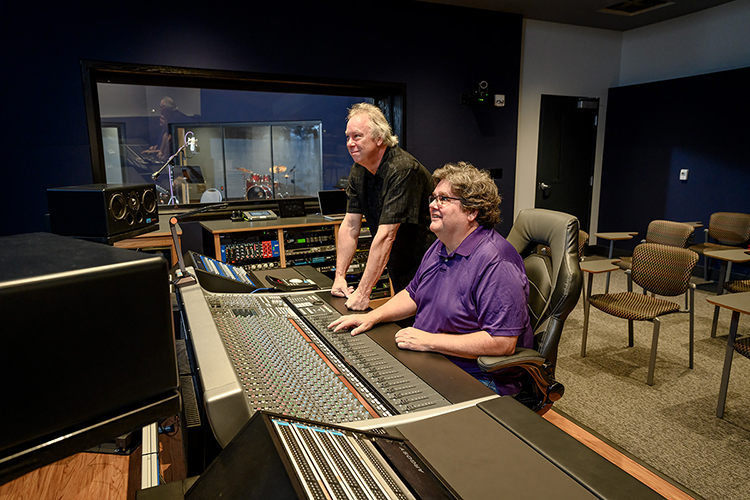 Professors Bill Crabtree, seated, and Dan Pfeifer of the Department of Recording Industry at Middle Tennessee State University work at the mixing console in the control room of Studio D, one of the department's two newly relocated, customized, expandable recording facilities for students in the East Main Building on campus. Crabtree, who directs the department's Master of Fine Arts in Recording Arts and Technologies degree program, and Pfeifer are the co-chairs of a committee overseeing the nearly $2 million studio project, which covers almost 5,000 square feet of recording space, control rooms, equipment rooms and an open gathering/reception area. (MTSU photo by J. Intintoli)