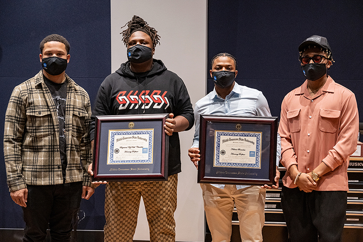 Memphis native and Grammy-nominated hip-hop producer BryTavious “Tay Keith” Chambers, second from left, holds the honorary professorship certificate he received from Middle Tennessee State University Wednesday, Sept. 29, during a special “sneak-peek” visit to his alma mater for a tour of the MTSU Department of Recording Industry’s new studios on campus. Pictured from left are Chambers’ manager, former MTSU student and Howard University grad Cambrian Strong; Chambers; MTSU alumnus Nick Brownlow, Chambers’ PR director and executive at their Drumatized record label and production company, who was also honored; and fellow MTSU alumnus Tyland Jackson, Chambers’ stylist. (MTSU photo by Cat Curtis Murphy)