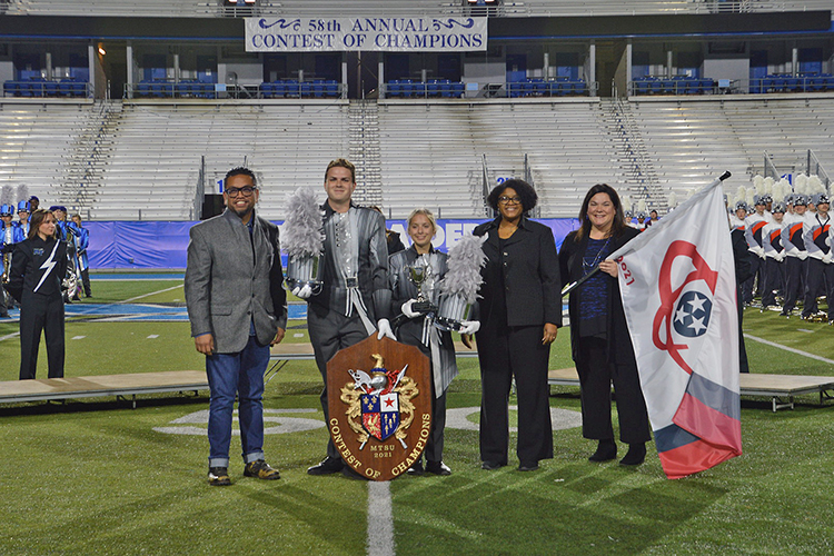 Pope High School of Marietta, Ga., took home the grand champion prize for their performance at the 58th Contest of Champions held Saturday, Oct. 23, at Floyd Stadium. Presenting the band with their awards are, far right, Jennifer Vannatta-Hall, interim director of the MTSU School of Music, and next to her, Leah Lyons, interim dean of the MTSU College of Liberal Arts. At left is Henry Go from Innovative Percussion. (Submitted photo)
