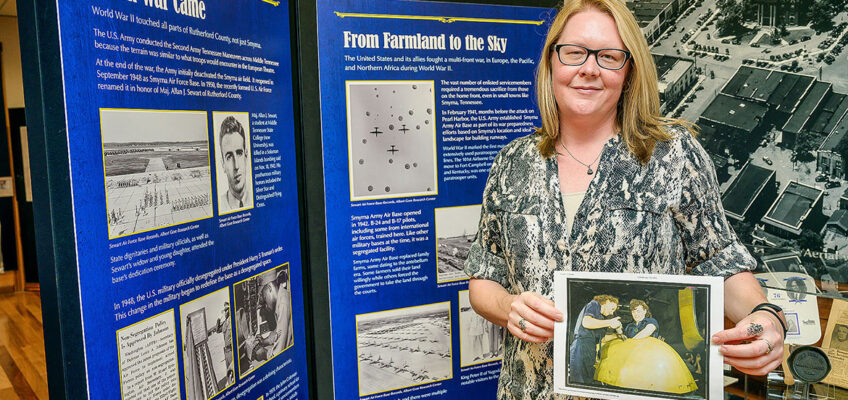 Kira Duke, education specialist at Middle Tennessee State University’s Center for Historic Preservation, holds a Library of Congress digital collection photo of Tennessee women working on a WWII “Vengeance” dive bomber, at the Heritage Center of Murfreesboro and Rutherford County in Murfreesboro, Tenn., on Oct. 13, 2021. MTSU’s center recently landed a $43,000 Library of Congress grant for a research project centered around the impact of WWII on Tennesseans. (MTSU photo by Andy Heidt)