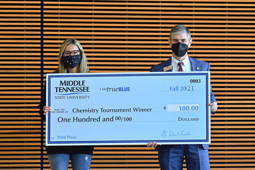 Central Magnet School senior Emma Tellez, left, recently received a $100 cash prize from College of Basic and Applied Sciences interim dean Greg Van Patten for placing third in the recent Chemistry Scholarship Tournament in the Science Building. Tellez also received a $1,000 scholarship. (MTSU photo by Cat Curtis Murphy)