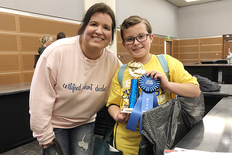 Hayden Thornell, right, and his mom, Jill Thornell, both of Murfreesboro, pose with Hayden's Judges’ Favorite All-Grade Entrepreneur and the All-Grade Entrepreneur awards in MTSU's Student Union Ballroom Thursday, Feb. 17, at the 29th annual Invention Convention. Hayden, a fifth grader at Erma Siegel Elementary School, invented a new business, "Classy Cactus Farm" gift boxes of succulent plants, and developed his award-winning marketing plan for it. His mom now runs the day-to-day family business operations. Hayden was one of 700-plus fourth-, fifth- and sixth-grade students from 36 schools across the Midstate who showcased their inventions to make life easier, their newly invented games and their entrepreneurship plans for their projects. (MTSU photo by Gina E. Fann)