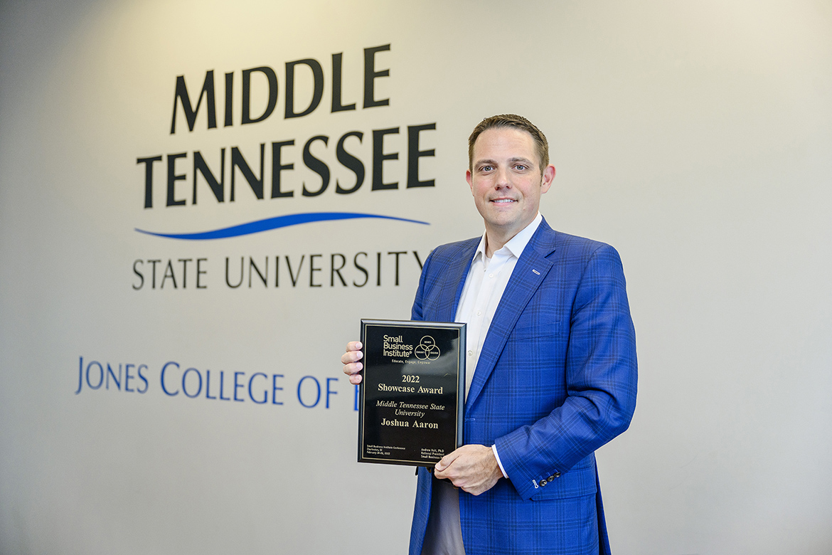 MTSU management professor Joshua Aaron, Pam Wright Chair of Entrepreneurship in the Jennings A. Jones College of Business, holds the Small Business Institute’s 2022 “Showcase Award” inside the Business and Aerospace Building. Aaron accepted the award, signifying the top entrepreneurship program of the year within the professional development organization, at the annual SBI national conference in Charleston, South Carolina, in late February. (MTSU photo by J. Intintoli)