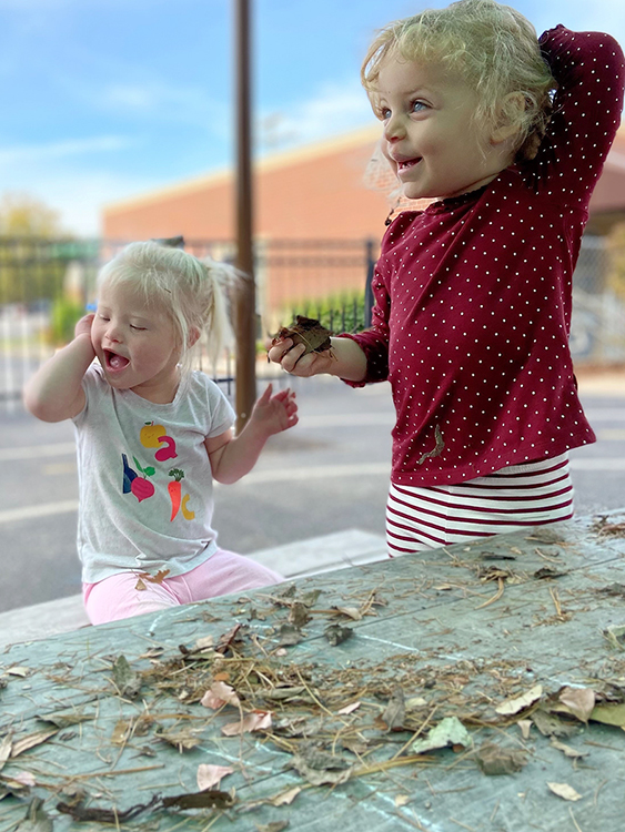 Two of the little learners at MTSU's Ann Campbell Early Learning Center laugh in the breeze while studying leaves and grass in the center’s playground in this file photo. The nonprofit, inclusive preschool, an arm of MTSU’s College of Education, is welcoming supporters of all ages to its 15th annual "Saddle Up" fundraiser on Saturday, April 30. For more information, visit https://www.mtsu.edu/acelearningcenter/saddleup.php. (Photo courtesy of the Ann Campbell Early Learning Center at MTSU)