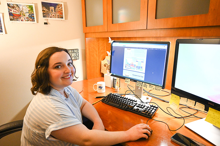 Bethany Cardenas, who works on communication projects at Middle Tennessee State University’s College of Graduate Studies, clicks through the college’s new “Campus Quest!” virtual scavenger hunt instruction guide that she helped design on Aug. 16, 2022, at the Sam H. Ingram Building on campus. (MTSU photo by Stephanie Barrette)