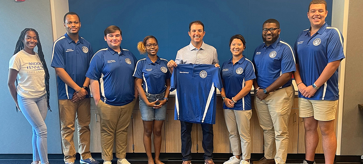 Murfreesboro Mayor Shane McFarland, center, an MTSU alumnus and former student government president, poses with the MTSU Student Government Association Executive Board after receiving an SGA polo shirt with his name on it. McFarland spoke at the Center for Student Involvement and Leadership retreat Wednesday, Aug. 3, at Murfreesboro Police Department headquarters. (MTSU photo by Danny Kelley)